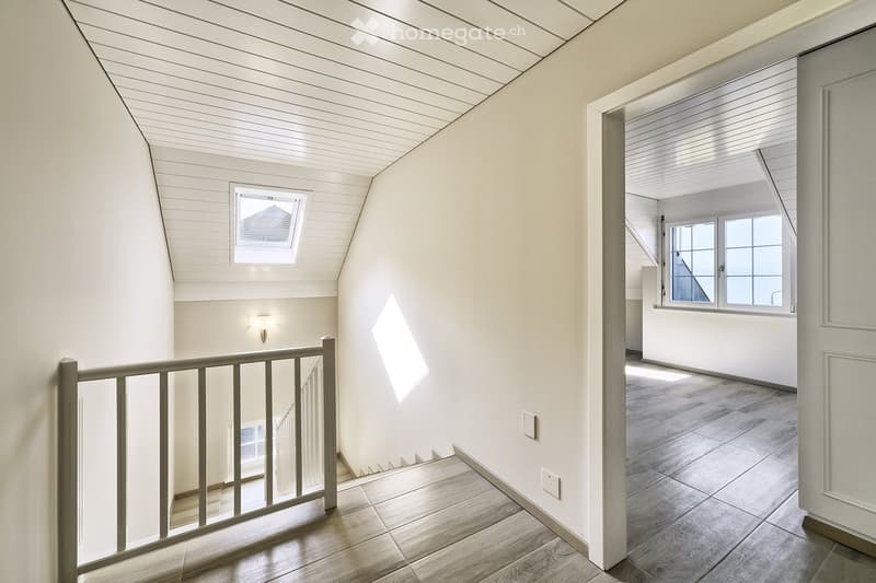 white walls, wooden floor, white ceiling, windows, staircase