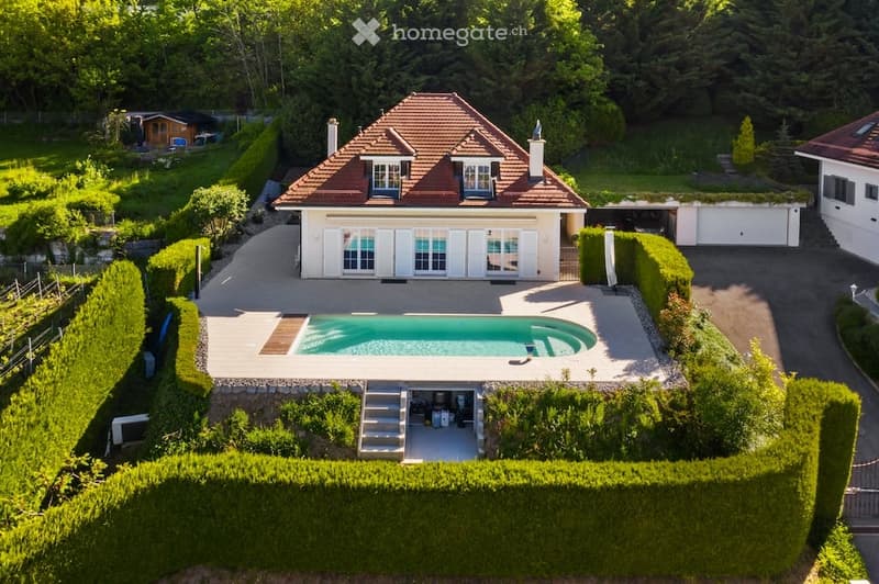 House with swimming pool, garage, and a view of the surrounding area