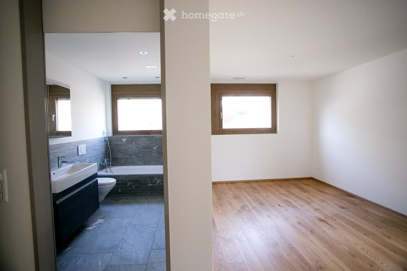Bathroom with bathtub, sink, toilet, and windows