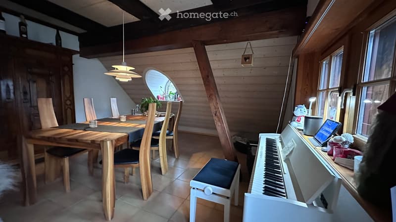 dining room with wooden table, chairs, piano, windows, wooden beams
