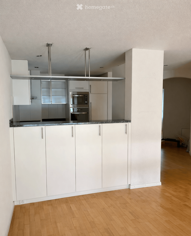modern kitchen with white cabinets, granite countertop, stainless steel appliances, wooden floor