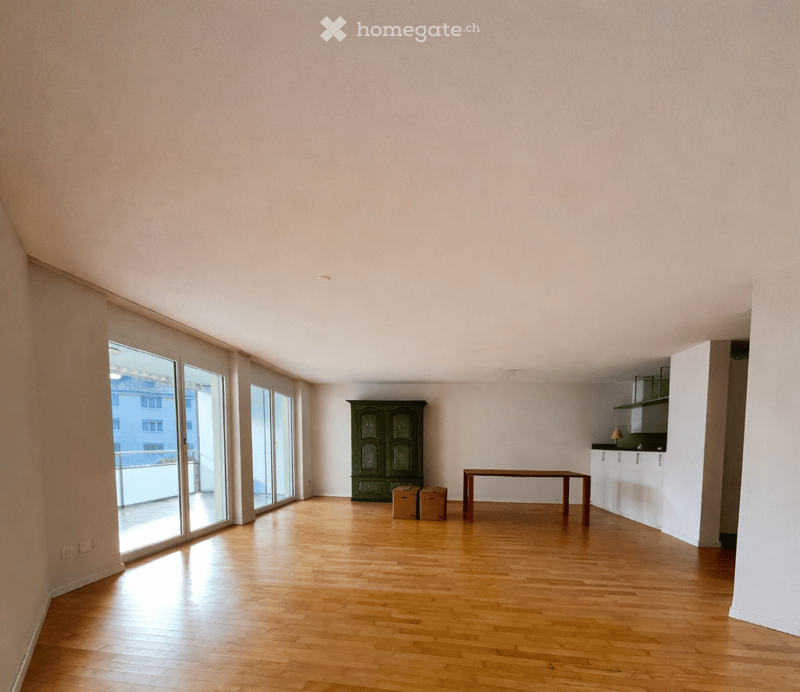 empty room, wooden floor, sliding glass doors, balcony, green cabinet, table, boxes