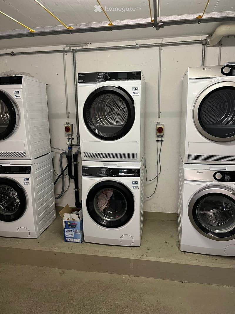 Stacked washing machines and dryers in a utility room