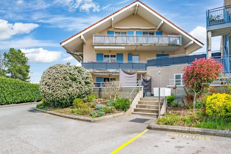 2 story house, blue shutters, balconies, garden, parking area
