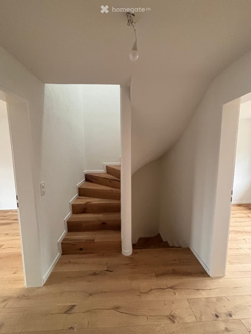 wide wooden staircase, white walls, wooden floor, open to two rooms