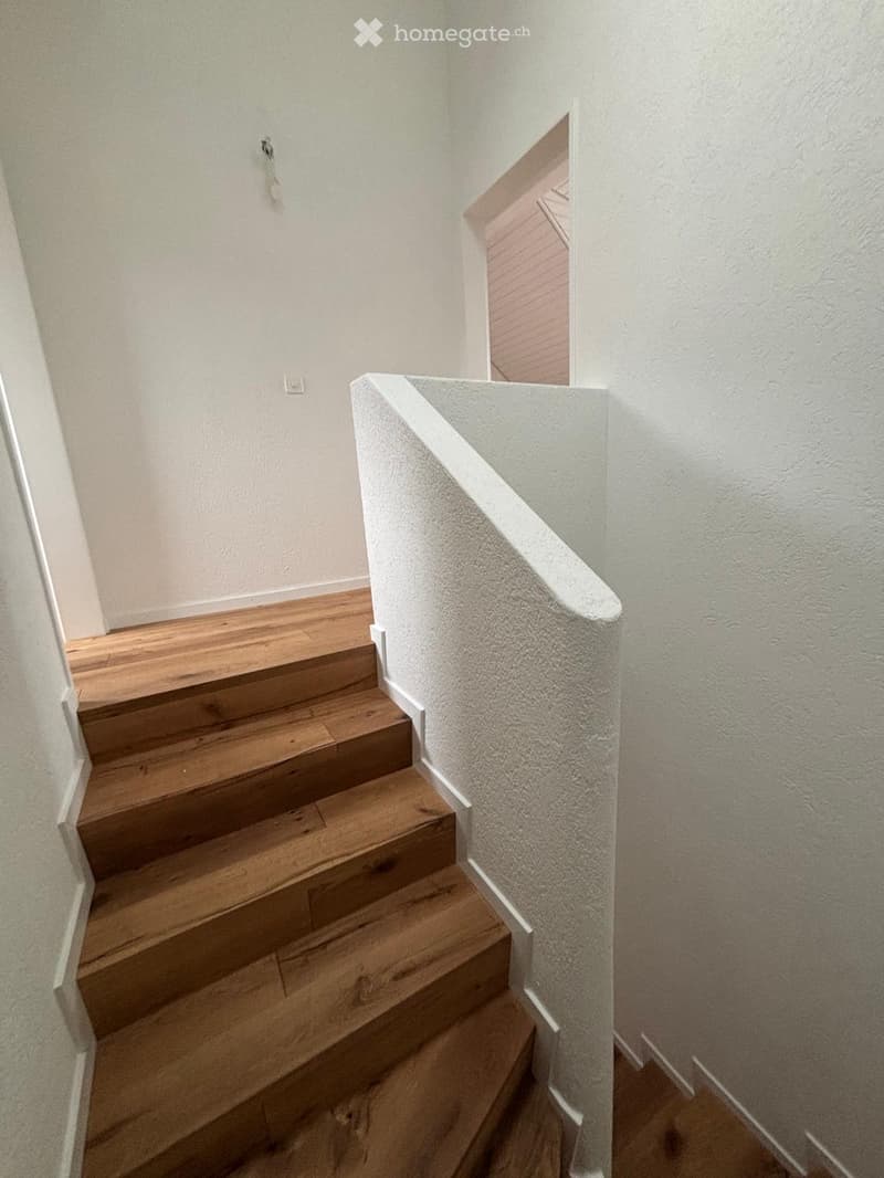 wooden steps, white railings, white wall