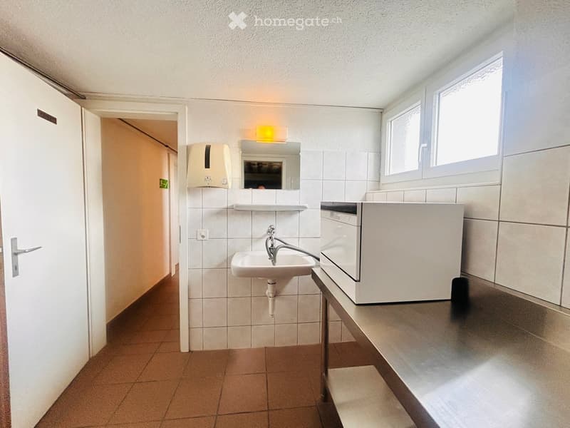 A small room with a sink, a dishwasher, and a washing machine.