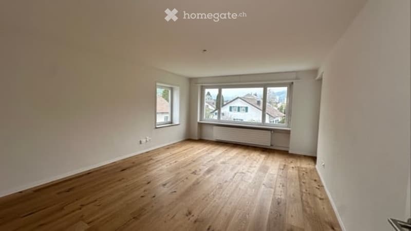 empty room, wooden floor, white walls, two windows, view of the outside