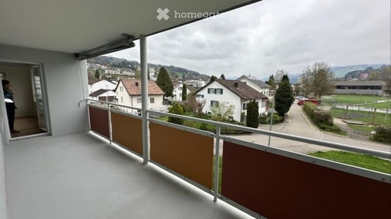 Balcony with railings, view of the town, white walls, white floor