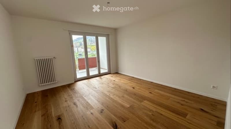 empty room, wooden floor, white walls, sliding glass door, balcony, radiator