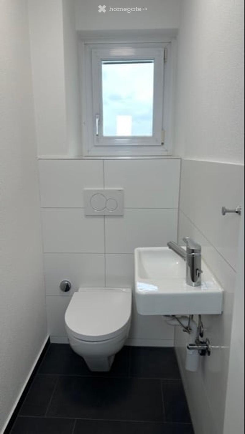 small bathroom with toilet, sink, window