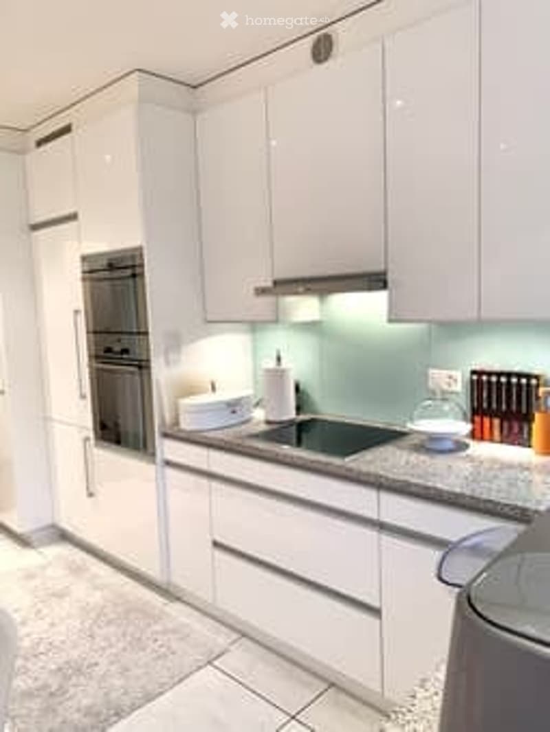 modern kitchen, white cabinets, granite countertops, built-in oven and stove, island, dishwasher, white appliances, tiled flooring