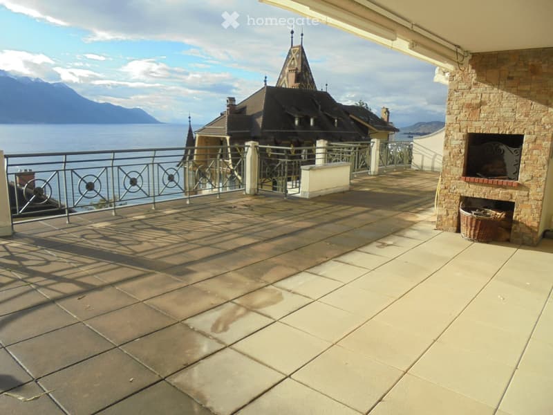 tiled floor, metal railing, fireplace, view of the sea and mountains