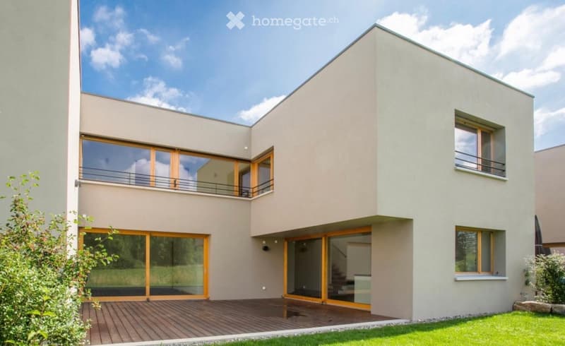Modern house, beige exterior, large glass windows, wooden deck, 2 balconies