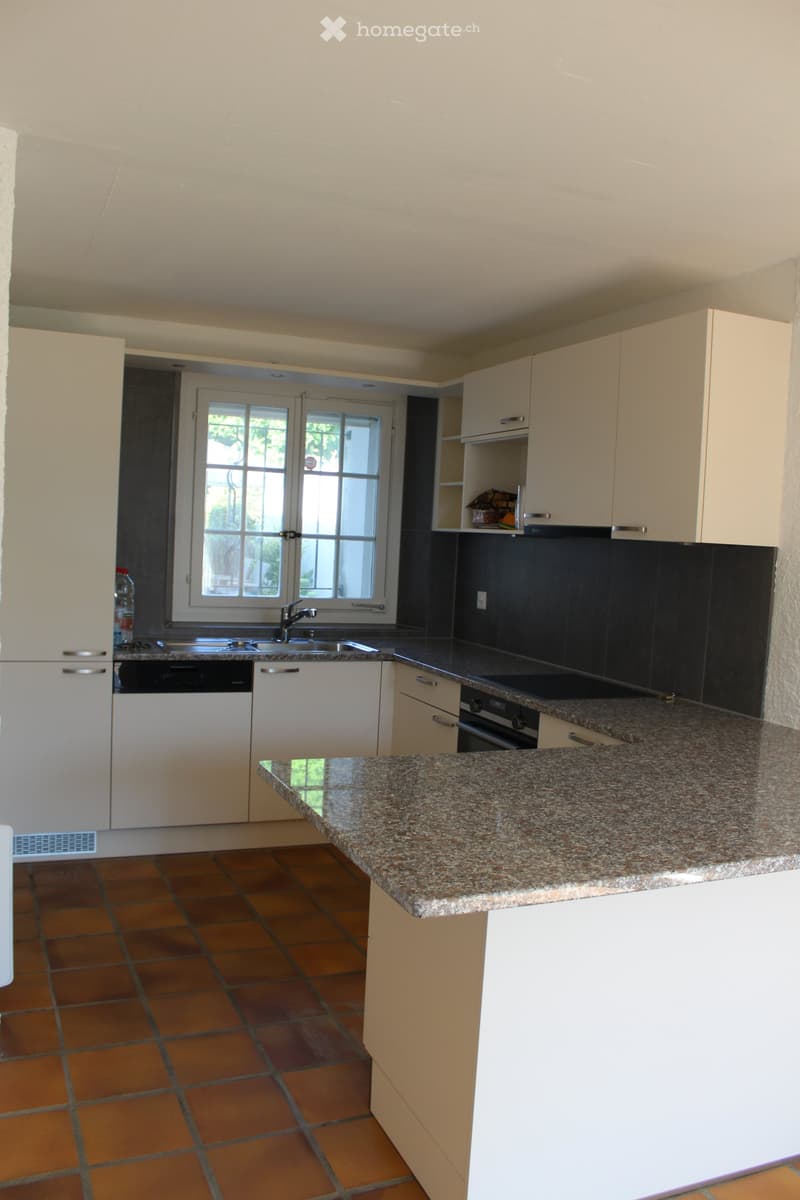 modern kitchen with granite countertops, white cabinets, stainless steel sink, dishwasher, washing machine, window with view