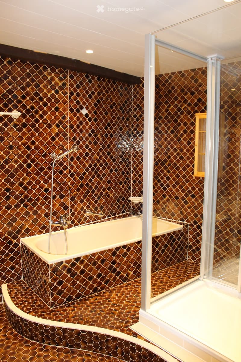 Bathtub, shower, hexagonal tiles, wooden cabinet, silver fixtures