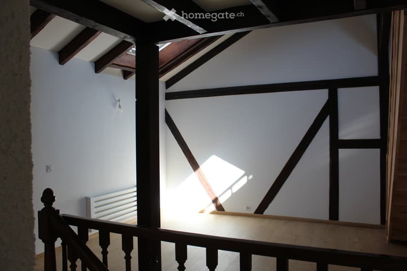 empty room, wooden beams, white walls, wooden floor, radiator, stairs