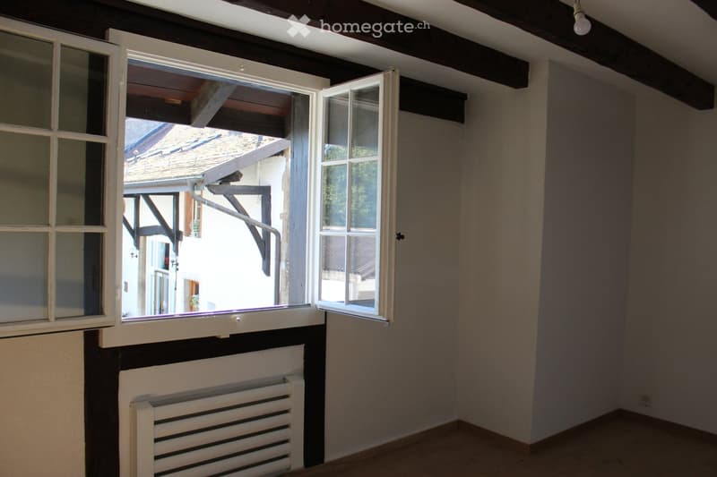 empty room, white walls, wooden floor, white radiator, open window, wooden ceiling