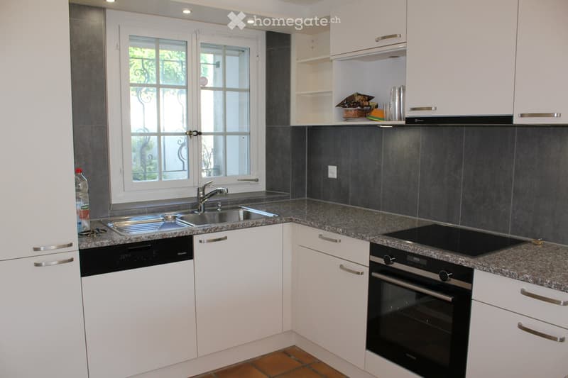 modern kitchen with white cabinets, granite countertops, stainless steel sink, dishwasher, oven, window