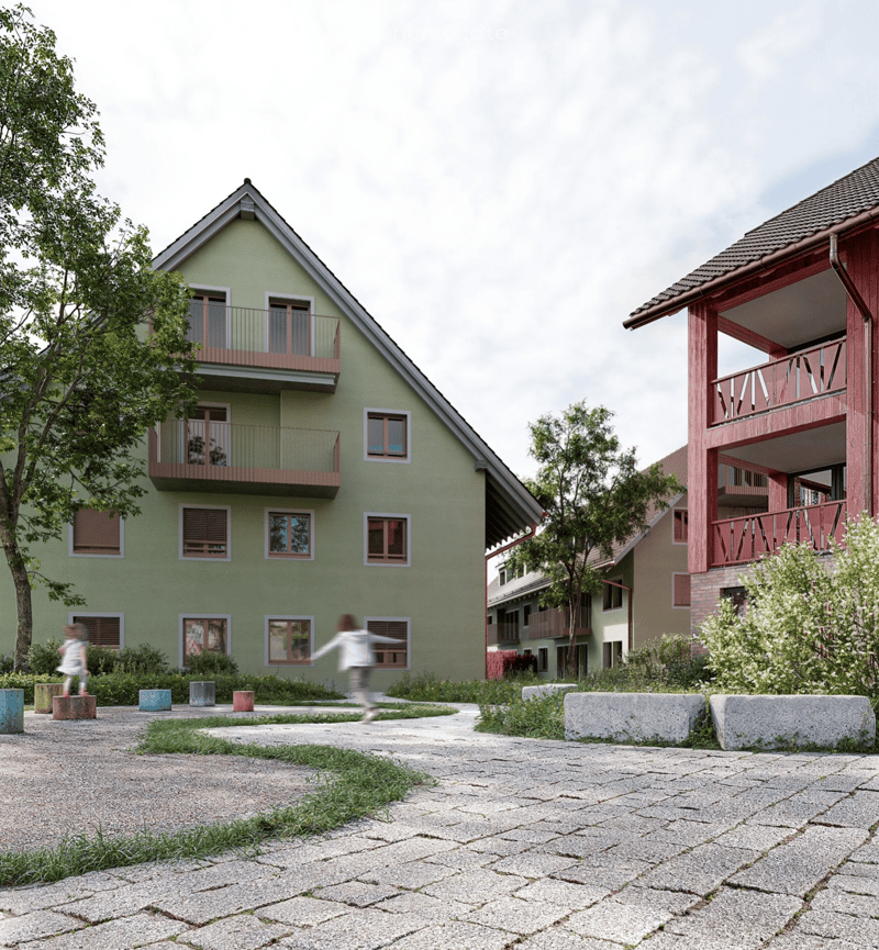 3 story residential building with balconies, red roof, green walls, paved front yard