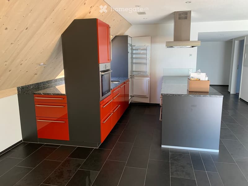 modern kitchen with black tiles, red and gray cabinets, built-in oven, refrigerator, island with countertop, open shelving