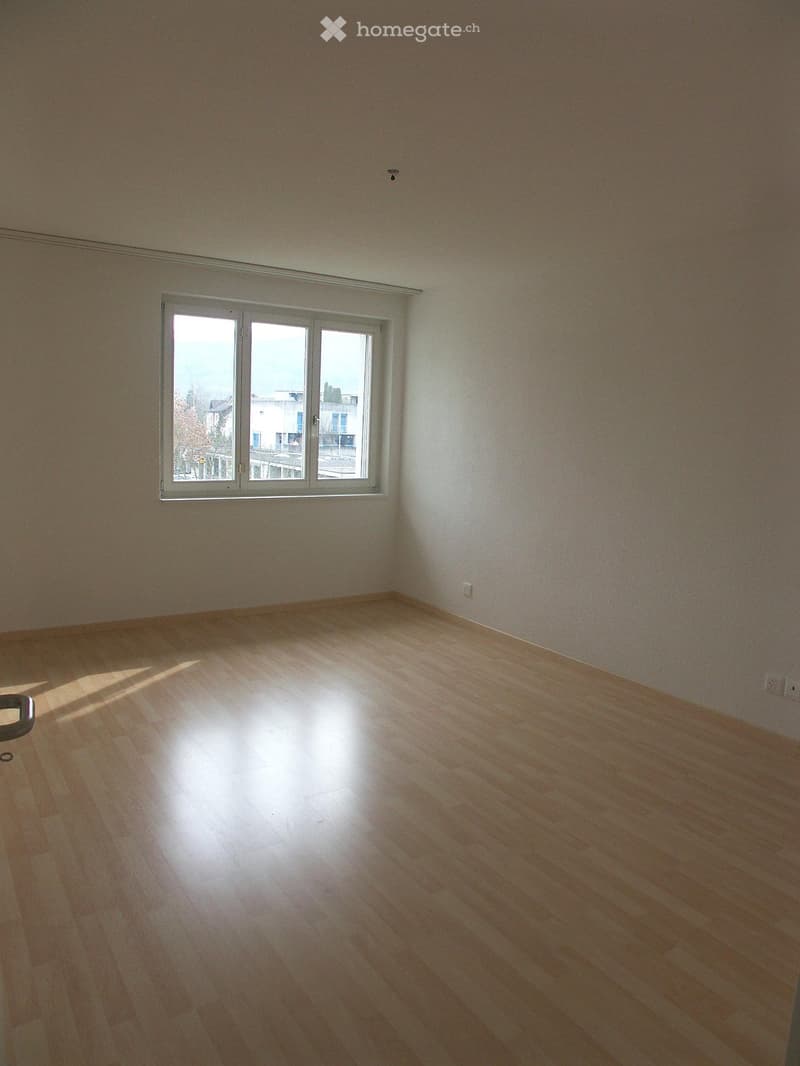 empty room, wooden floor, white walls, large window, power outlets