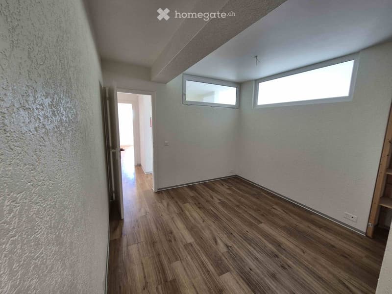 empty room, wooden floor, white walls, two windows, open door