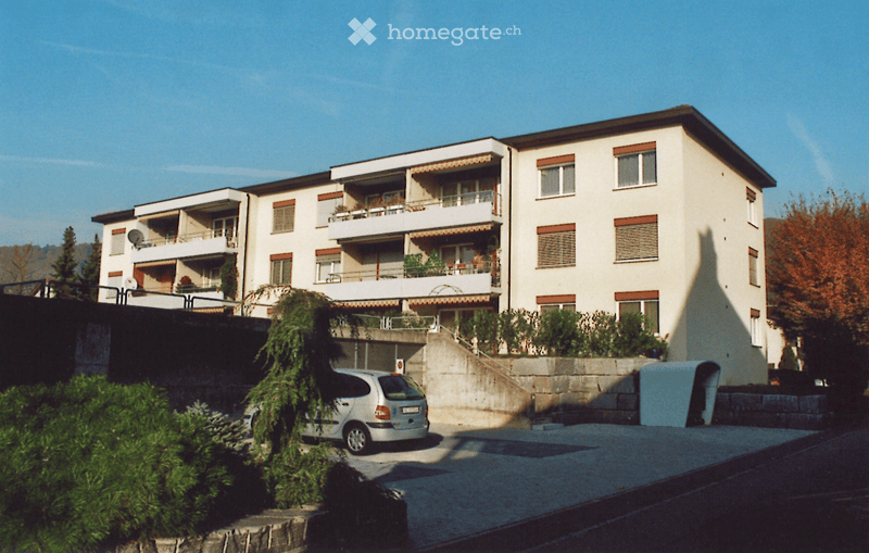 3 story apartment building, balconies, parking place