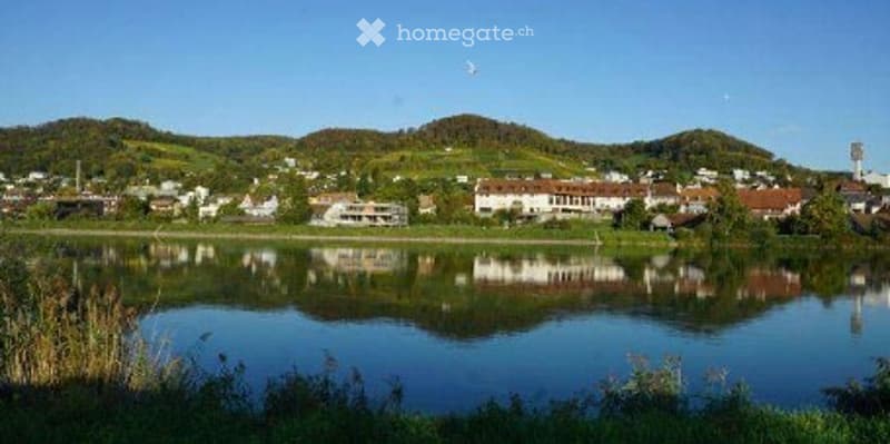 River, houses, mountains, clear sky