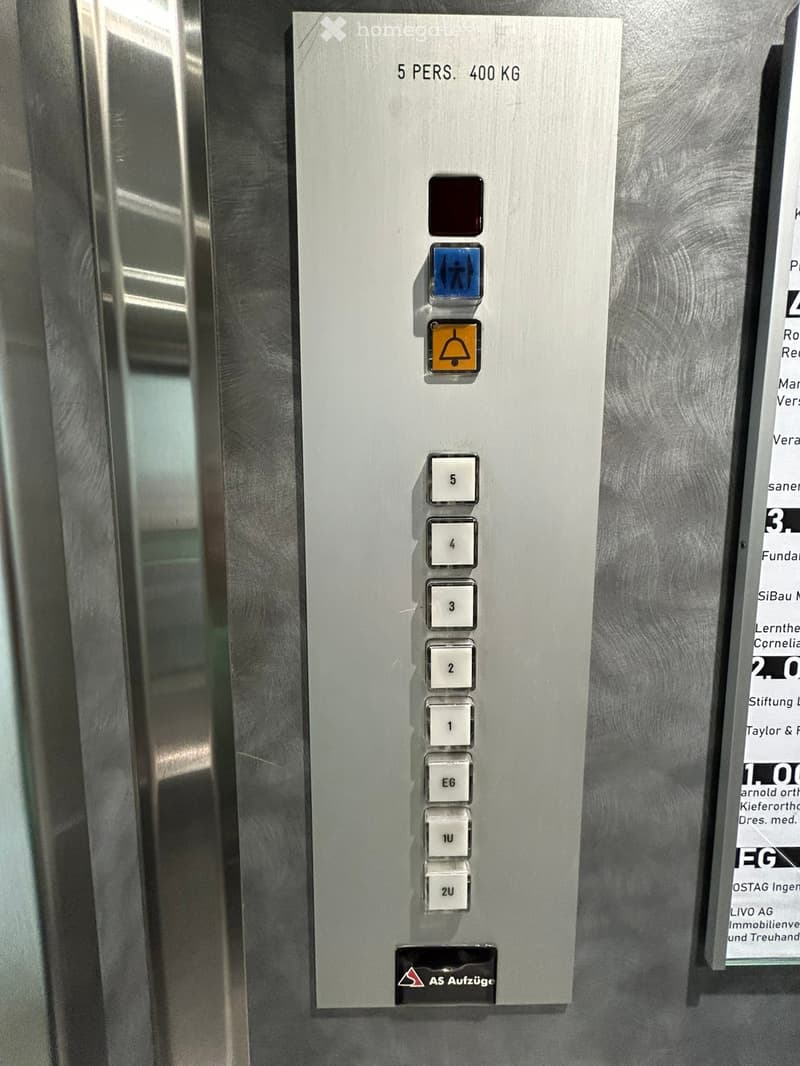 Elevator control panel with buttons for floors 5 to 2U, emergency call button, and wheelchair access button.