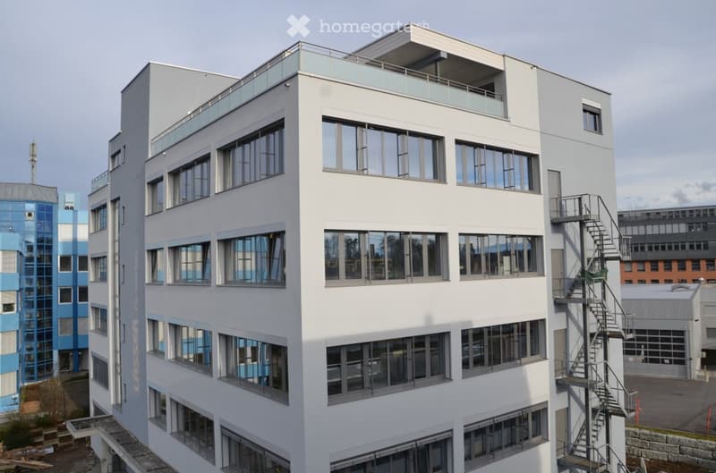 modern office building, white exterior, large windows, balcony on top floor