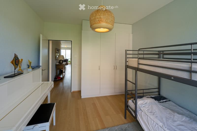 white piano, white cabinet, white bunk bed, white wardrobe, wooden floor, lamp