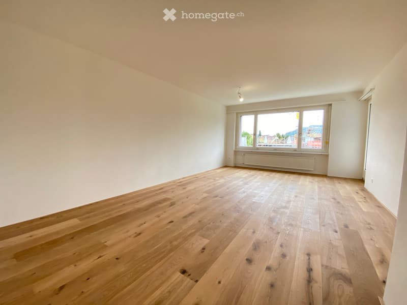 empty room, wooden floor, white walls, large window, view of the outside