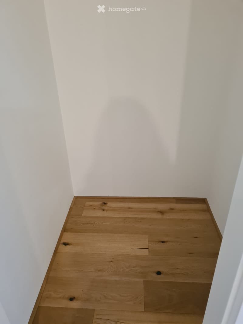 empty room with white walls and wooden floor