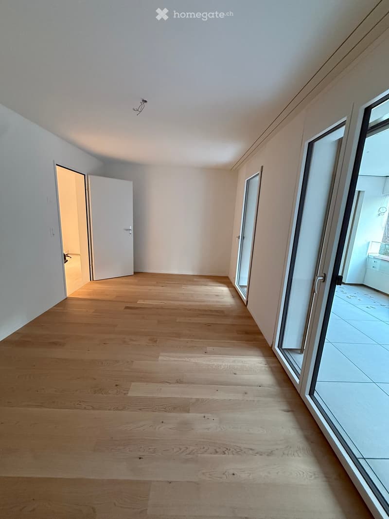empty room, wooden floor, white walls, sliding glass doors, open door