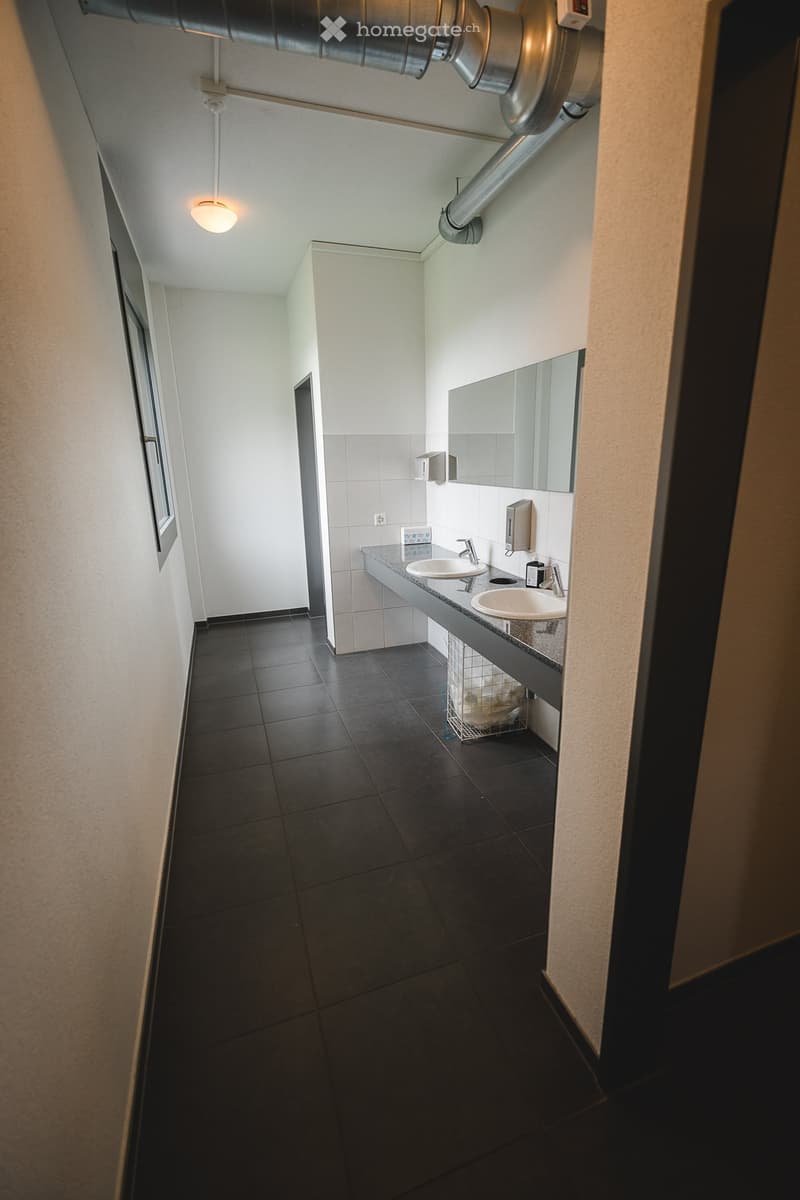 Bathroom with two sinks, mirror, and a window