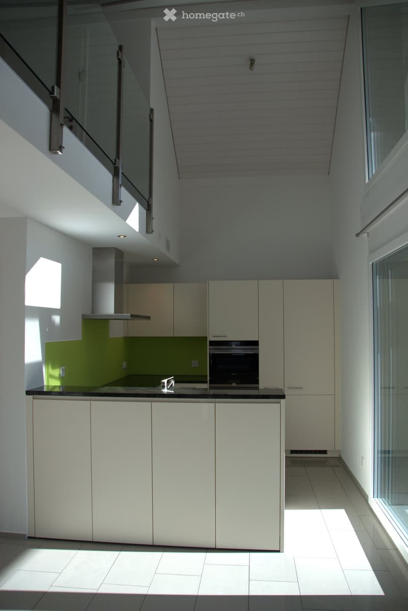 Modern kitchen, white cabinets, tiled floor, built-in oven and microwave, stainless steel faucet, large window, balcony