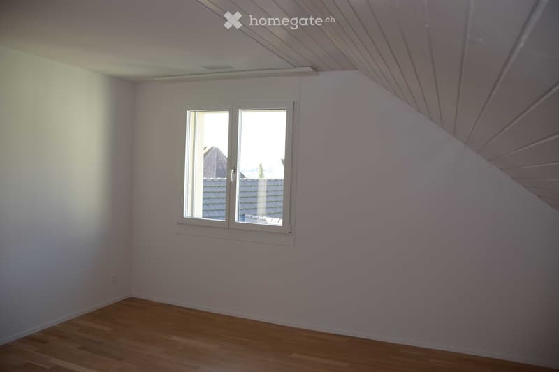 empty room with window, white walls, wooden floor