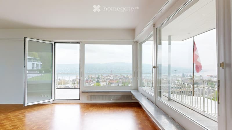 large windows, balcony, wooden floor, white walls, radiator
