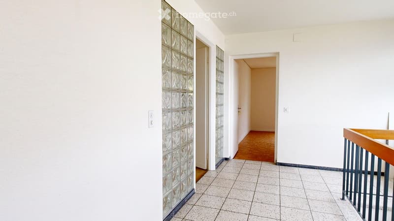 white walls, white tile floor, glass wall, wooden railing, empty room