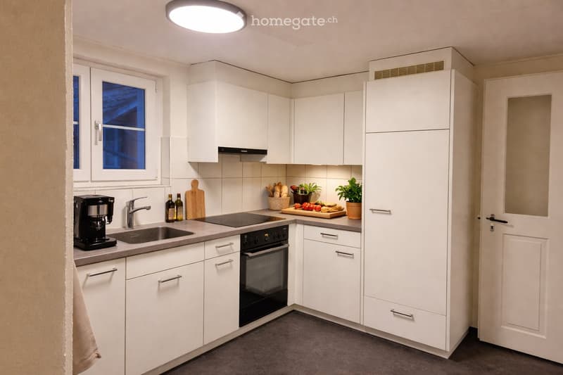 modern kitchen with white cabinets, granite countertops, black appliances, and a window