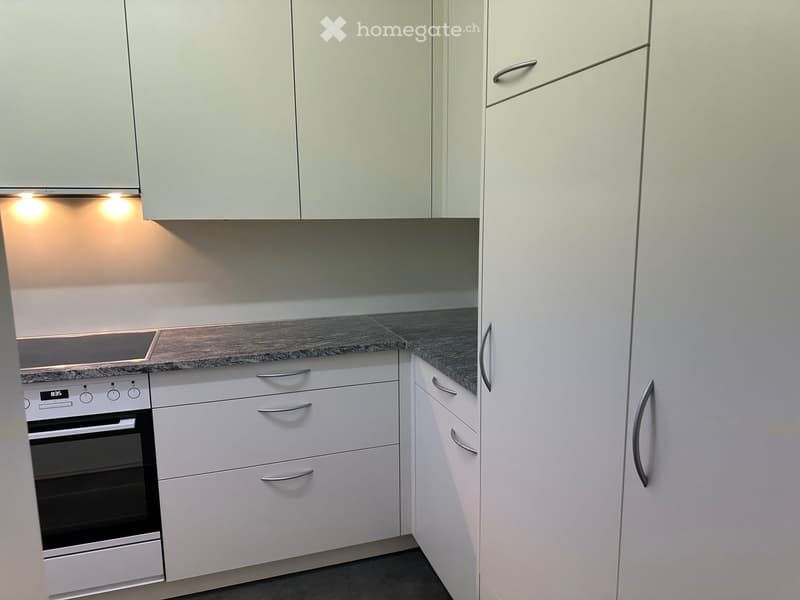 modern kitchen with white cabinets, granite countertop, built-in oven and dishwasher, granite backsplash