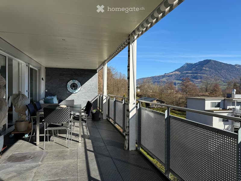 Tiled floor, dining table, chairs, metal railing, mountain view
