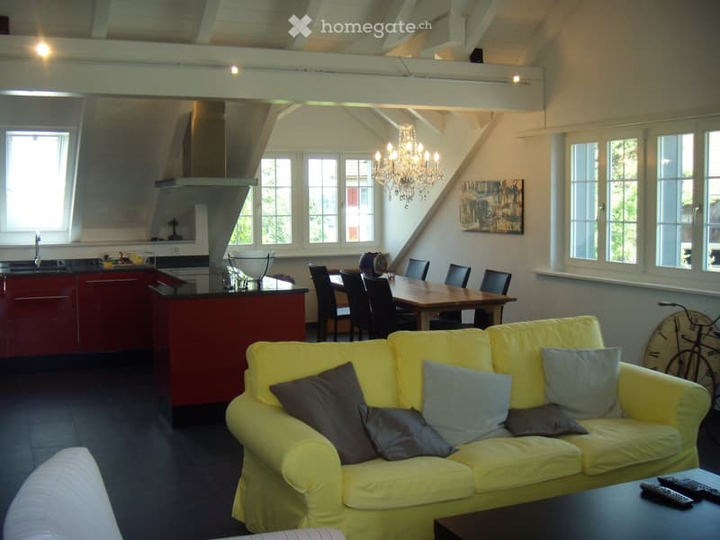 yellow couch, dining table, chandelier, kitchen, windows