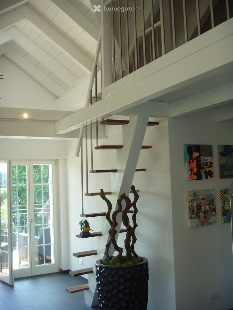 modern staircase, white walls, wooden floor, large plant, glass doors, outdoor seating