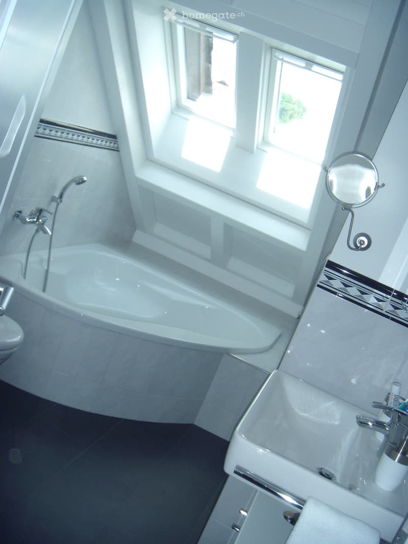 Bathroom with bathtub, sink, mirror, and toilet
