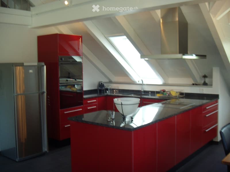 modern kitchen with red cabinets, granite countertops, stainless steel appliances, gas stove, oven, extractor hood, sink, faucet, window, skylight