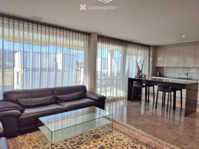 modern living room with large windows, leather couch, glass coffee table, kitchen island, bar stools, marble flooring