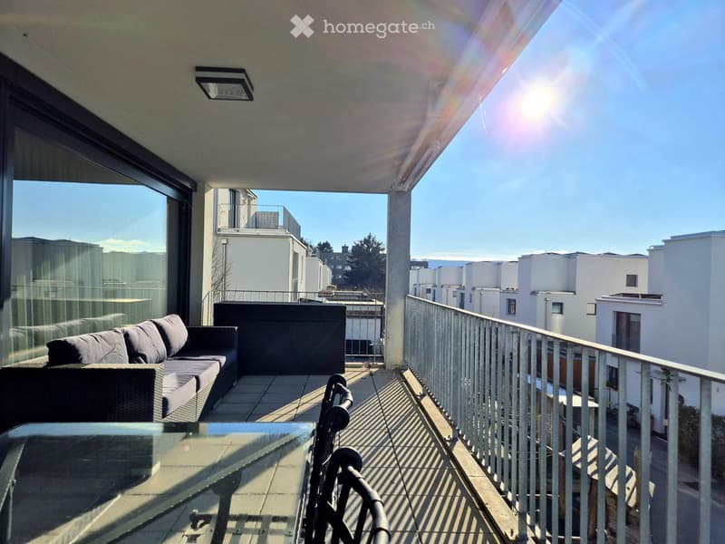 Balcony with couch, table, chairs, metal railing, glass wall, metal ceiling