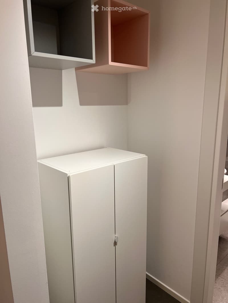 Closet with two compartments on wall, white wardrobe, tiled floor